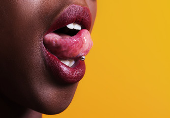 African girl tongue stuck out showing piercing