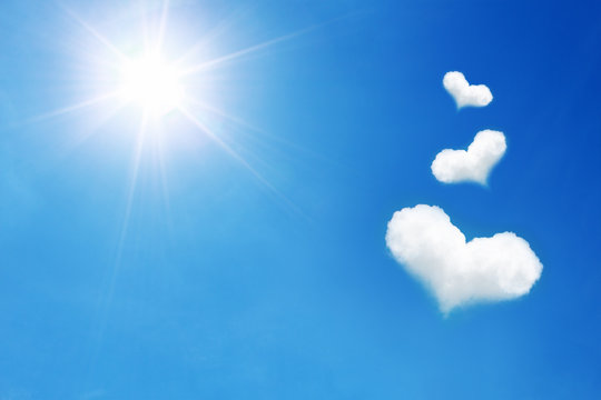 three heart shaped cloud on blue sky with sunshine
