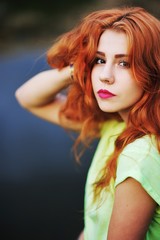 Fototapeta premium Portrait of an adorable brown-eyed girl with her hand up, combin