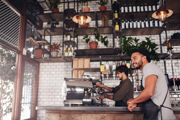 Coffee shop owner standing at the counter