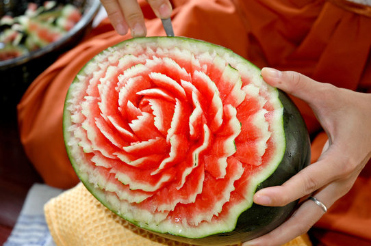 crafts carved watermelon with the hand and carving knife