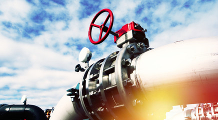 Industrial zone, Steel pipelines and valves against blue sky