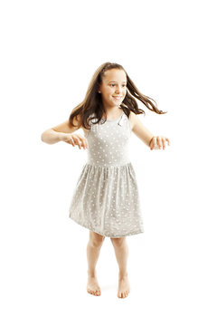 Adorable young girl dancing. Isolated on white background