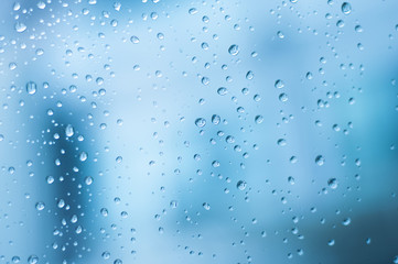 Drop water on glass in blurred blue tone background