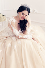 fashion interior photo of gorgeous bride in luxurious wedding dress with accessories 