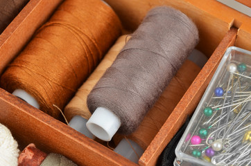 Fototapeta na wymiar Threads on wooden box