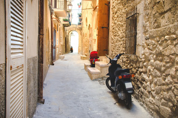 Fototapeta na wymiar moped parked on a narrow alley
