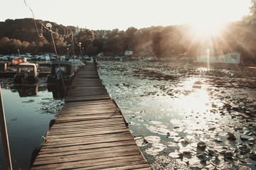 River boat dock on the sunset background