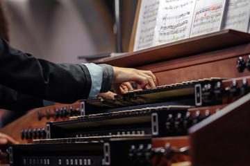 organist playing a pipe organ