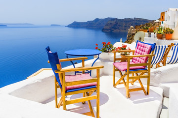 Two chairs with table on a terrace in Santorini, Greece