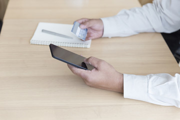 businessman's hand with mobile phone and credit card for shoppin