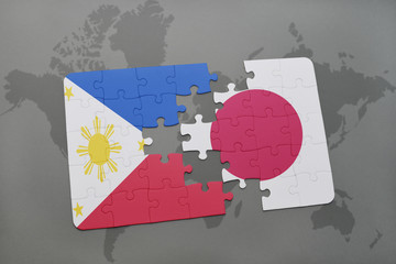 puzzle with the national flag of philippines and japan on a world map background.