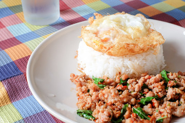Fried egg on Rice topped with stir-fried pork and basil