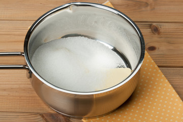 Fototapeta na wymiar Butter And Sugar In Sauce Pan. Cooking Process. Bakery Preparati