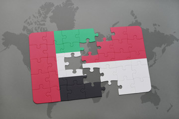 puzzle with the national flag of united arab emirates and indonesia on a world map background.