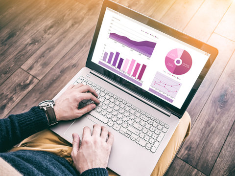 Man Working At Computer Laptop With The Finance Report On The Screen. Business Research, Economy Statistics