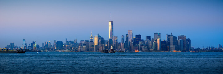 Fototapeta na wymiar Panoramic Lower Manhattan Financial District skyscrapers and New York City Harbor at twilight