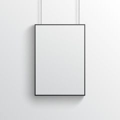 White poster with black frame mockup on grey wall