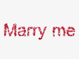 word  "Marry me" made of rose petals on white background . 3d render