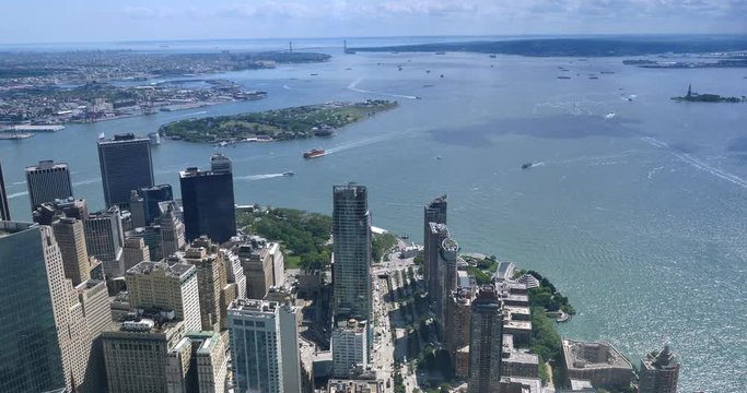 A unique high angle view of Lower Manhattan and Battery Park with Governors Island and the Verrazano-Narrows Bridge in the distance.  	