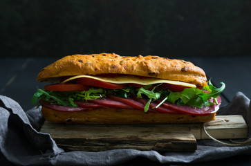 Sandwich with beef and cheese, arugula
