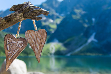 Two wooden heart on the background of the Mountain Lake Morskie Oko in the High Tatras  © mukiart