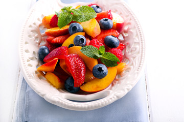 Fruit and berry salad on plate,