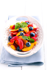 Fruit and berry salad on plate,
