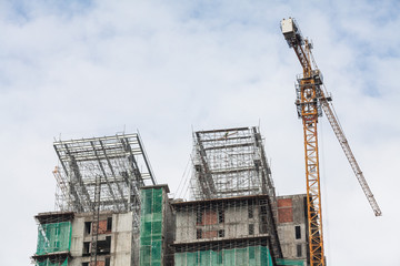 Fototapeta na wymiar Construction site view of crane, lift, metal beam, brick, metal ladder and concrete