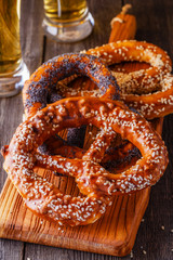 Pretzels and beer on a wooden background.