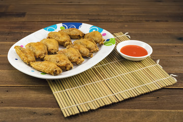 Fried chicken wings with hot sauce
