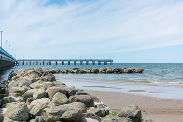 Fototapeta na wymiar Rocks and dock of Palanga beach in Lithuania