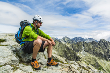 Hiker resting in mountains.