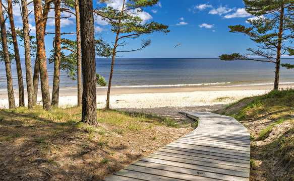 Wooden walkway leading to the sandy beach of the Baltic Sea, Latvia, Europe
