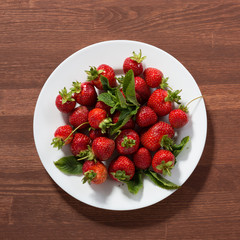 Ripe red strawberries on wooden table. Strawberry. Fresh strawberry. Red strewberry. Strawberry Juice. Loosely laid strawberries in different positions.