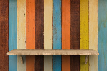 wooden shelf on colorful background
