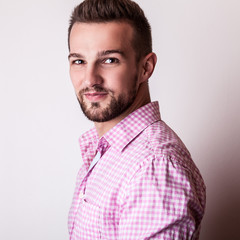 Young handsome man in colorful shirt pose in studio.