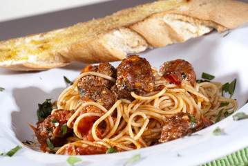 spaghetti bolognese with basil garnish