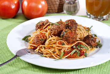 spaghetti bolognese with basil garnish