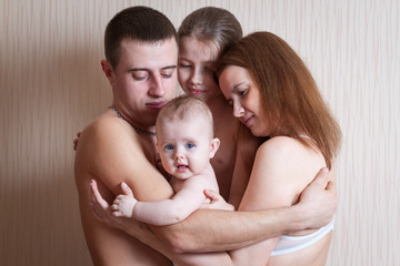 Family father, mother and two daughters indoors