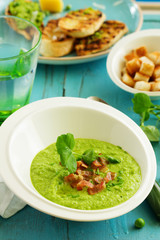 Soup of green peas with bacon and mint.