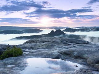 Landscape in water mirror. Misty awakening in beautiful mountains park