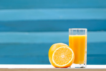 orange juice in a glass and fruit