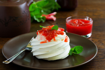 Dessert of meringue with rhubarb and mint sauce.