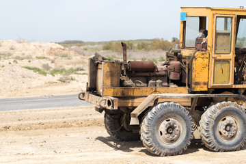 Fototapeta premium tractor to level the ground for the road