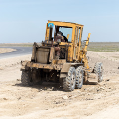 tractor to level the ground for the road