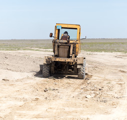 Obraz premium tractor to level the ground for the road