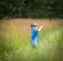 Young boy playing on fields in countryside