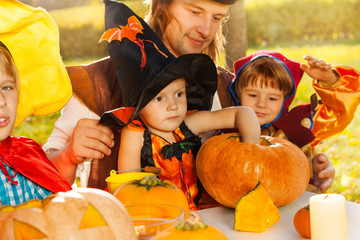 Fototapeta premium Cute kids and father in Halloween costumes