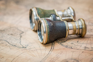 Pair of binoculars on an old map